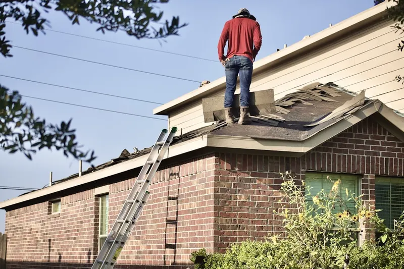 Professional roofer working on a residential roof in Miller Valley